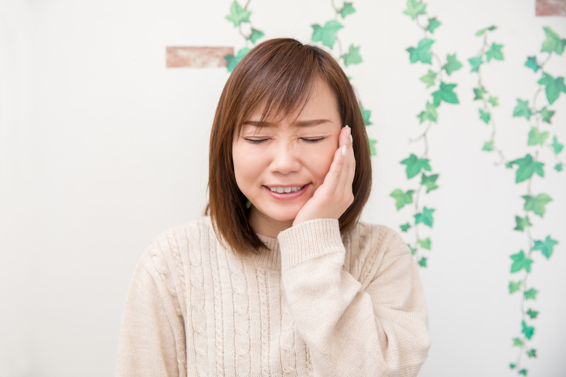 頬を押さえる女性